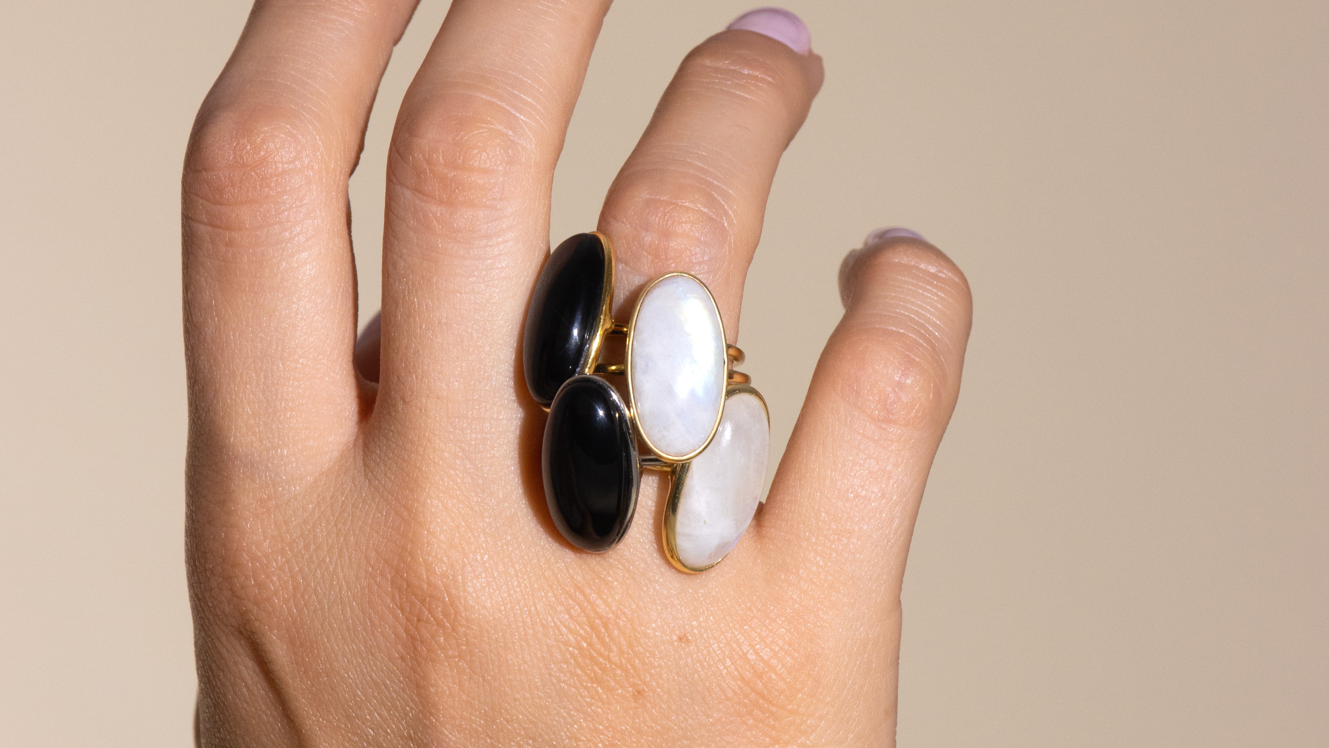 4 rings on one fingers with 2 natural rainbow moonstones and 2 black onyxes.